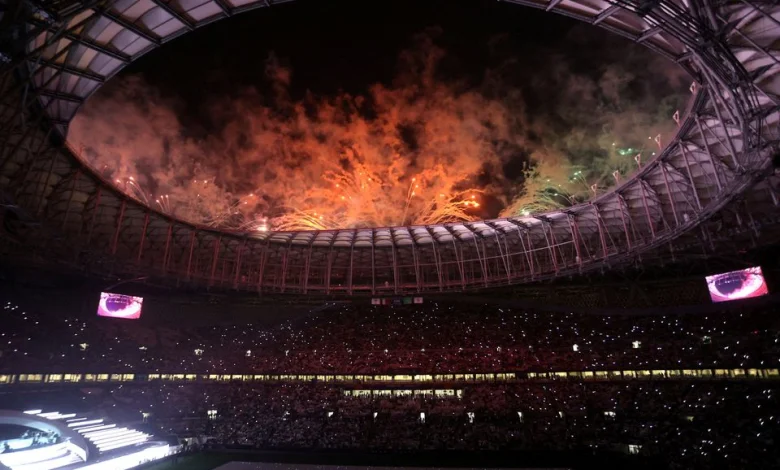 a large stadium with fireworks in the sky
